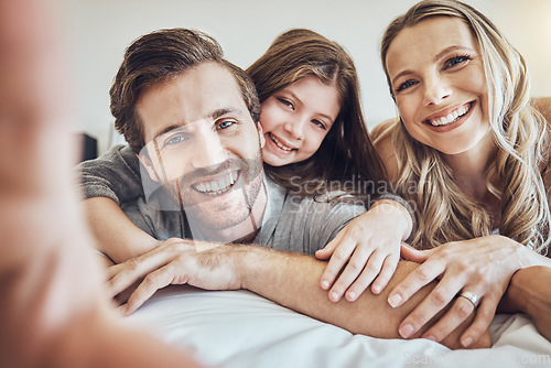 Image of Portrait, smile or parents take a selfie with a girl as a happy family in house bedroom bonding in Berlin. Mother, father or child relaxing together enjoying quality time or taking pictures at home