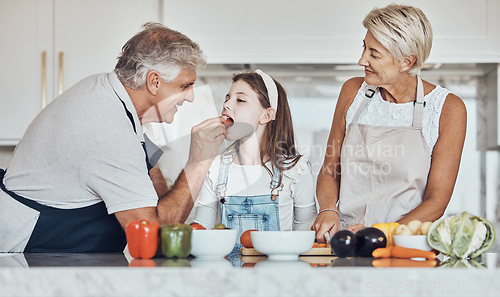 Image of Love, grandparents or girl cooking or eating as a happy family in house kitchen with organic vegetables for dinner. Grandmother, old man or young child bonding or helping with healthy vegan food diet