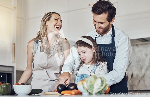 Image of Learning, happy family or girl cooking or cutting vegetables in a kitchen with healthy food for dinner. Development, father or funny mother laughing, teaching or helping a kid or child in a meal