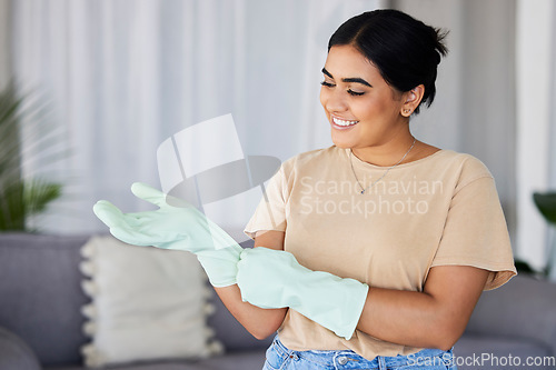 Image of Cleaning, woman and gloves on hands in home for housekeeping, maintenance and safety. Happy cleaner, housewife and smile in apartment while ready for domestic chores, services and dirt free lifestyle