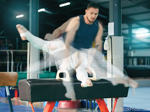 Image of Gymnastics, fitness and man on balance beam for training, cardio and strength at gym. Athletic, male and acrobat practice speed, control and sport routine for muscle, power or endurance performance