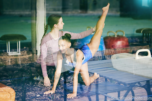 Image of Help, gymnastics and sports athlete with coach training at the gym learning and assisting with exercise. Teaching, stretching and gymnast in a workout or preparing balance for a competition