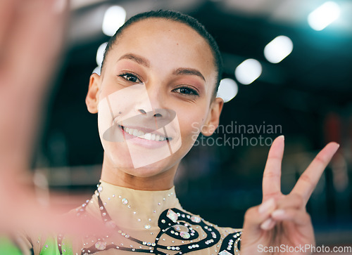 Image of Selfie, peace and olympics with a black woman gymnast in a gym posing for a picture while training alone. Portrait, hand sign and gymnastics with a female athlete in a studio for fitness or exercise