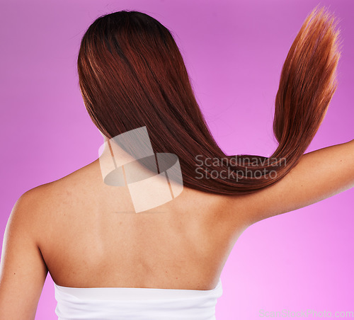 Image of Back, woman and hair motion in studio with color dye, beauty and salon shampoo. Behind long hairstyle, cosmetics and clean textures of model for shine, growth and aesthetic wellness of healthy scalp