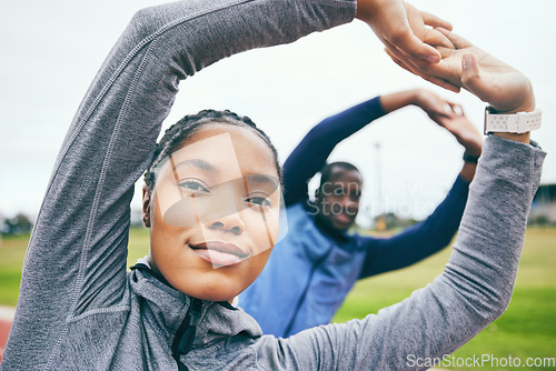 Image of Portrait, black woman on field and stretching for fitness, workout and training for wellness, health and balance. Exercise, man and African American female athlete stretch arms, outdoor and practice