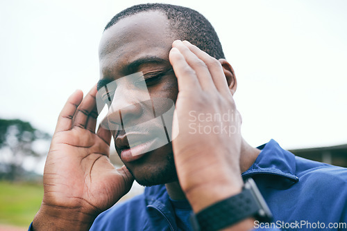 Image of Black man, stress and headache after exercise, workout or training practice outdoors. Sports wellness, fitness and mental health of tired male athlete with pain, burnout or migraine after running.