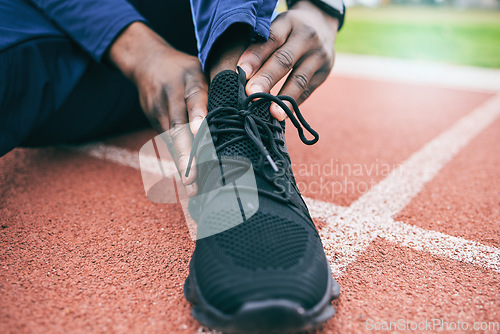 Image of Sports, feet and man with ankle pain from exercise, workout and marathon training in stadium. Fitness, runner and shoes of athlete with joint strain, injury and arthritis from running on field track