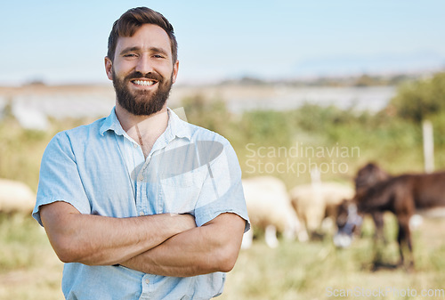 Image of Farmer, portrait or arms crossed on livestock agriculture, sustainability environment or nature for farming industry. Smile, happy or confident man with animals growth or sheep and person on a field