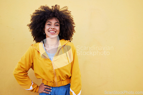 Image of Portrait, fashion and mockup with an afro black woman in studio on a yellow background for style. Trendy, hair and mock up with an attractive young female posing alone on product placement space