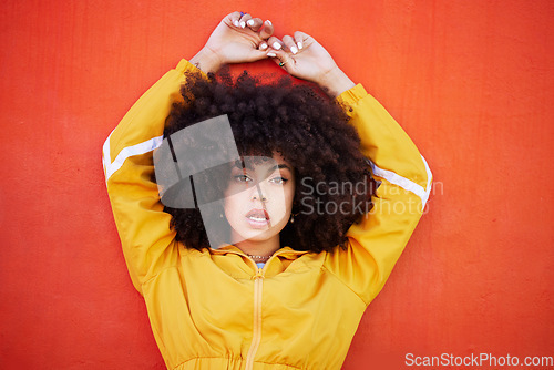 Image of Portrait, fierce and black woman with attitude, power and empowerment with afro on studio background. Face, African American female creative and lady with confidence, casual outfit and motivation