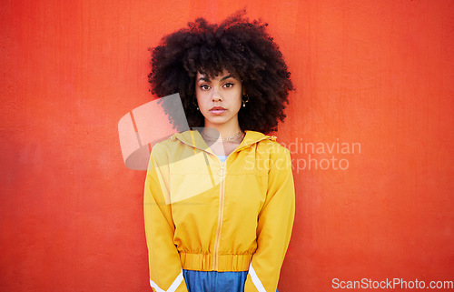 Image of Portrait of woman with natural hairstyle on red background, model with afro and red copy space. Confident young person with serious expression, curly hair and aesthetic fashion on studio wall