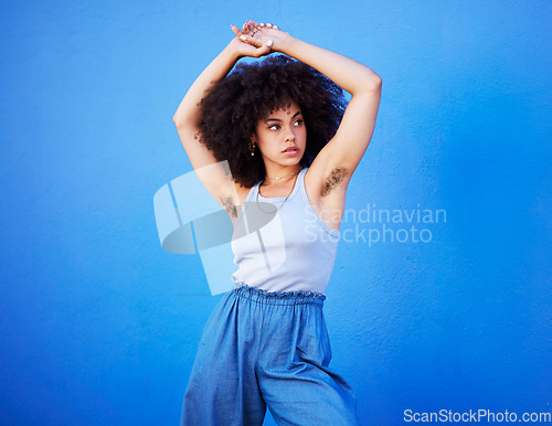 Image of Body positivity, empowerment and confident woman with hair isolated on a blue background. Beauty, natural and African girl showing armpit with confidence, feminism and attractive on a backdrop