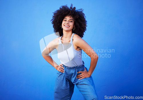 Image of Fashion, natural hair and black woman isolated on a blue background for gen z, youth or cool portrait with mockup. Afro person or beautiful model with style, confidence and happy in studio space