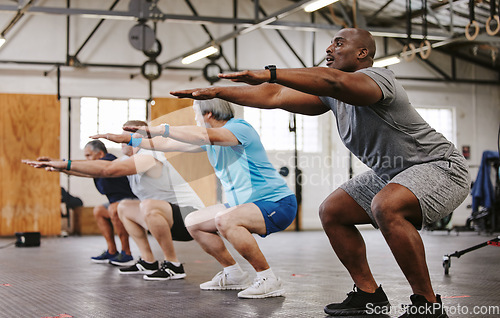 Image of People, fitness and stretching in class at gym for workout, squat exercise or training together. Diverse group or team in warm up stretch session for sports, health and cardio wellness at gymnasium