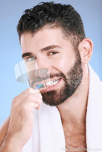 Image of Brushing teeth, man and studio portrait of toothbrush for dental wellness, healthy lifestyle or mouth care. Happy face, male model and oral cleaning of fresh breath, smile and happiness on background