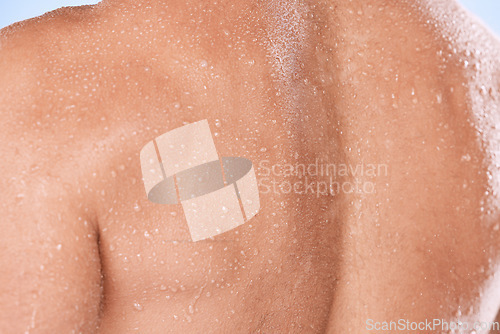 Image of Man closeup, back and water drops for shower, fitness and skincare hygiene for cosmetics, health and dermatology. Shoulder, body zoom and person with workout, exercise or sports muscle training sweat