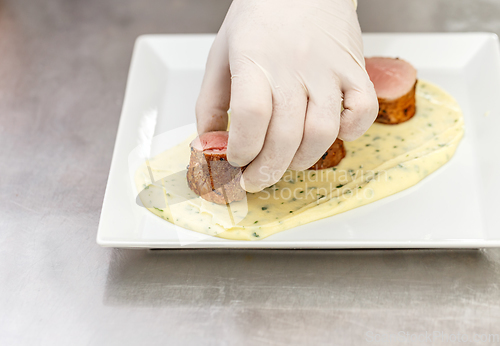 Image of Chef garnishing his dish