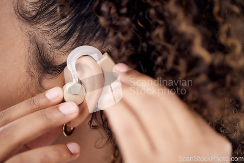 Image of Closeup, deaf and woman with cochlear implant for hearing, audio and aid for disability or impairment. Sound, hands and girl fitting device to help with communication, listening and interaction