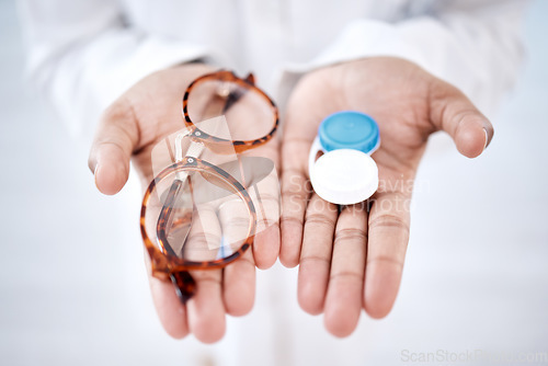 Image of Eye care, choice with glasses or contact lenses in hands, closeup and vision with healthcare for eyes. Prescription lens, person with frame and plastic container, optometry with optician and health