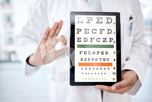 Image of Hands, tablet screen and snellen chart in hospital for vision examination in clinic. Healthcare, ok gesture or woman, ophthalmologist or medical doctor holding technology showing letters for eye test