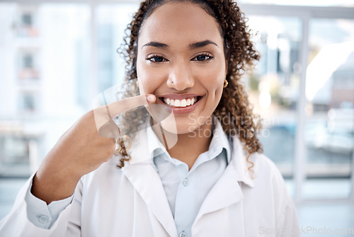 Image of Portrait of black woman pointing to teeth whitening results, dentist medical and mouth healthcare in hospital. Professional dental doctor with tooth cleaning services and happy face in USA clinic