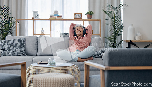 Image of Retirement, old woman and sofa with headphones, relax and calm in living room, streaming music and audio. Female senior citizen, happy mature lady and headset for podcast, radio and carefree on couch