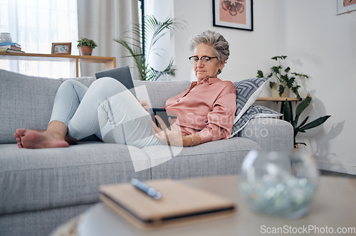 Image of Retirement, old woman on sofa and smartphone for connection, social media and chatting. Female senior citizen, elderly lady and laptop to check pension fund, investments and relax on couch in lounge