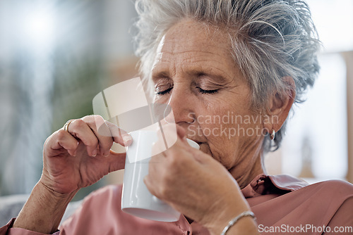 Image of Elderly woman, sofa and coffee to relax with drink for peace, quiet and me time to start morning in house. Senior lady, couch and tea for happiness, thinking and memory from aroma in home living room