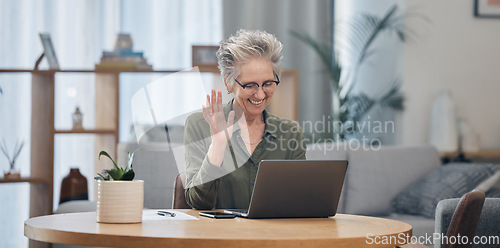 Image of Laptop, video call and remote work with a senior woman at work in her home office for business communication. Computer, virtual meeting and planning with a mature female employee waving at her webcam