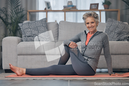 Image of Portrait, yoga and fitness with a senior woman in her home for mental health, wellness or spiritual zen. Exercise, floor and workout with a mature female doing pilates training in the living room