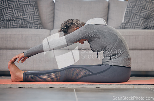 Image of Senior woman, yoga stretching and home on floor for wellness, health and fitness of body in retirement. Elderly lady, workout and training on in living room for healthy muscle, legs and calm mindset