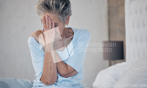 Image of Headache, sick and mature woman with depression, anxiety or mental health problem in the bedroom. Sad, stress and elderly person with insomnia, migraine pain and depressed from fatigue or divorce