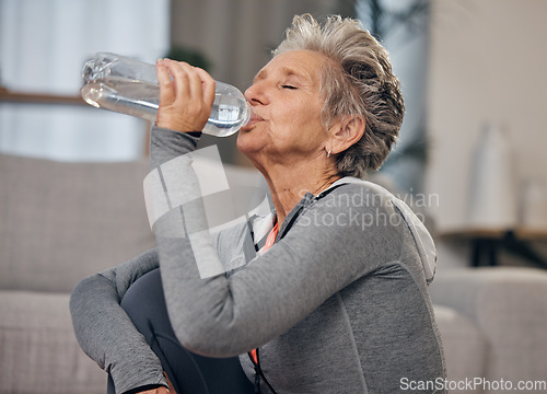 Image of Drinking, water and fitness with a senior woman in her home for wellness, hydration or retirement. Exercise, drink or thirsty with a mature female training in a house during a workout to stay active