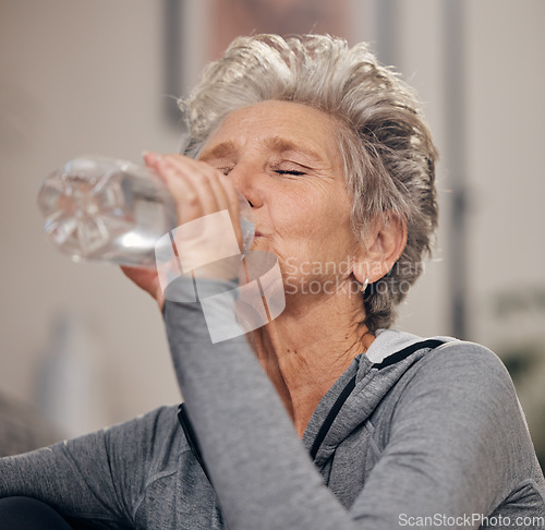 Image of Drinking water, fitness and retirement with a senior woman in her home for wellness or hydration. Exercise, drink or thirsty with a mature female training in her house during a workout to stay active