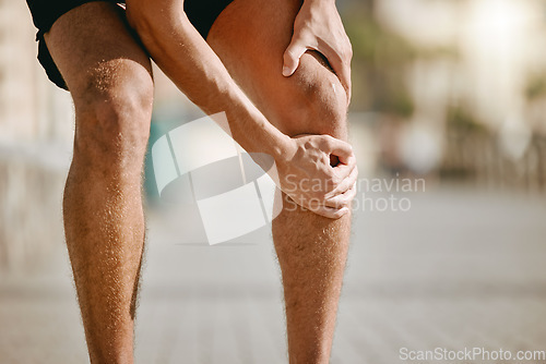 Image of Knee pain of runner or man hands for fitness healthcare risk, muscle accident or training problem in city. Running, cardio and workout legs injury of athlete person stop in street for muscle massage