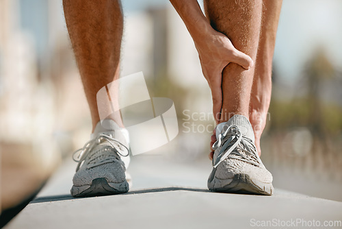Image of Ankle pain of runner or man hands for fitness healthcare risk, muscle accident or training problem in city. Running, cardio and workout foot injury of athlete person stop in street for legs massage