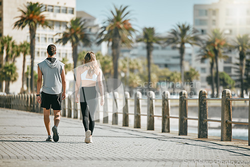 Image of Fitness, teamwork or mockup with a runner couple on the promenade for cardio or endurance from the back. Exercise, wellness or workout with a man and woman athlete running outdoor in the city