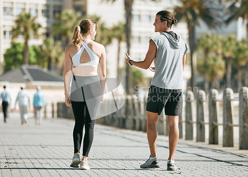 Image of Fitness, teamwork or health with a runner couple on the promenade for cardio or endurance from the back. Exercise, wellness or workout with a man and woman athlete running outdoor in the city