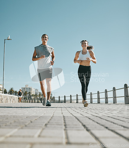 Image of Couple, fitness and running by beach in the city for exercise, workout or cardio routine together. Happy man and woman runner taking a walk or jog for healthy wellness or exercising in Cape Town