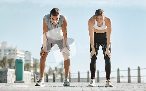 Image of Fitness, exercise and tired couple with blue sky to rest for health and wellness outdoor. Man and woman for city workout, cardio performance and healthy lifestyle for body fatigue, breathe and energy