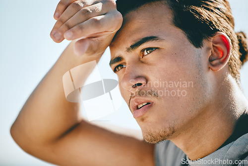 Image of Tired, fitness and sweating man for cardio training, workout or outdoor running break on blue sky. Focus, energy and fatigue athlete or sports person thinking of exercise goals or journey in summer