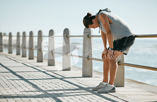 Image of Fitness, tired and breathing man for cardio training, workout or outdoor running break at beach. Breathe, thinking and fatigue of athlete or sports person with exercise challenge in summer by ocean