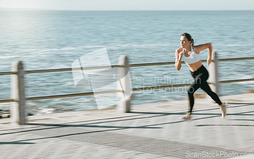 Image of Woman, fitness and running by beach on mockup for exercise, workout or cardio routine. Active female runner in fast speed run, sprint or race by the ocean coast for healthy exercising in Cape Town