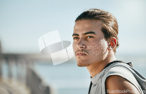 Image of Thinking, fitness and young man at beach for cardio training, workout or running break on blue sky mockup. Calm, mindset and focus of athlete or sports person with exercise journey by ocean or sea