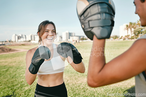 Image of Fitness, personal trainer and boxing woman outdoor for exercise in nature park for health and wellness. Couple of friends happy about sports workout or fight with support, motivation and man coach