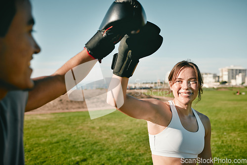 Image of Woman, personal trainer and boxing high five for win, achievement or success outdoor in nature park. Couple of friends happy for sport workout or fight training with motivation, energy and man coach