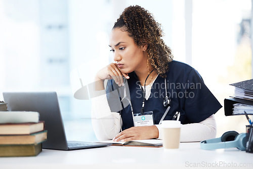 Image of Healthcare, laptop and research with a woman nurse reading information in a hospital for diagnosis. Medical, insurance and education with a female med student working in a clinic for data analysis