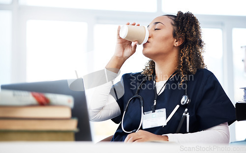 Image of Medical student, technology and drinking coffee in hospital studying burnout, education books research or wellness learning. Tired, nurse or healthcare woman with drink, laptop or medicine internship