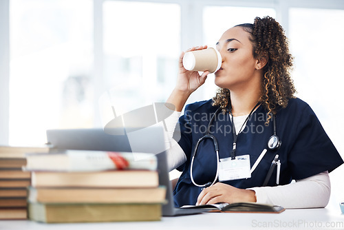 Image of Medical student, laptop or drinking coffee in hospital studying, education books research or wellness learning school. Thinking, nurse or healthcare woman and drink, technology or medicine internship