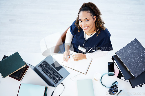 Image of Top view, portrait or nurse on hospital laptop research, education woman studying or books learning for medical student. Above, smile or happy doctor on healthcare technology in medicine internship